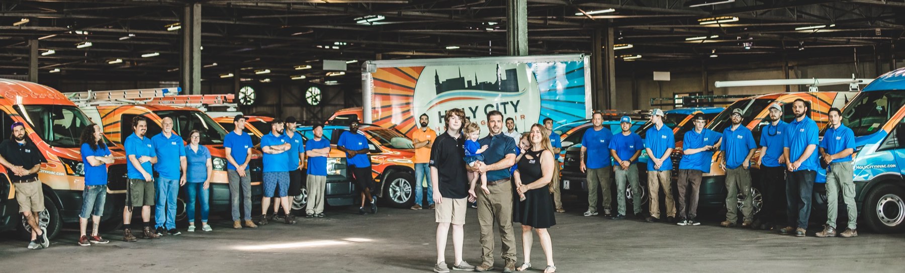 The entire Holy City Heating & Air team and the Harvey family with the wrapped fleet